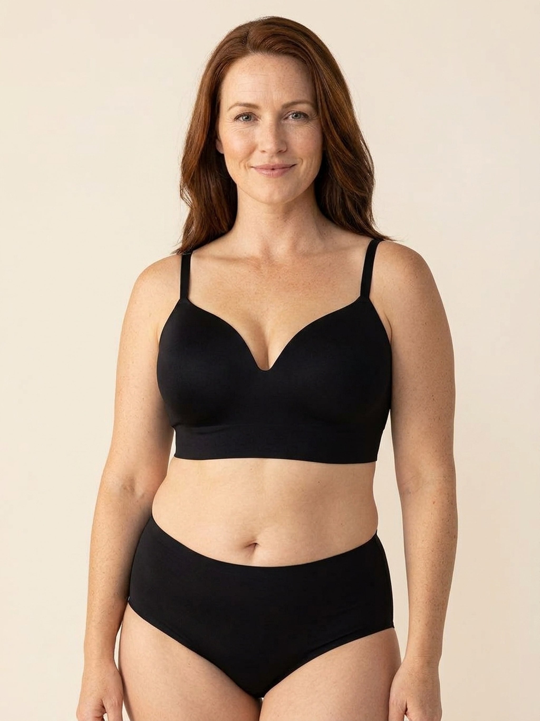 Snug wireless shaping bra in black, front view on a size 40G body