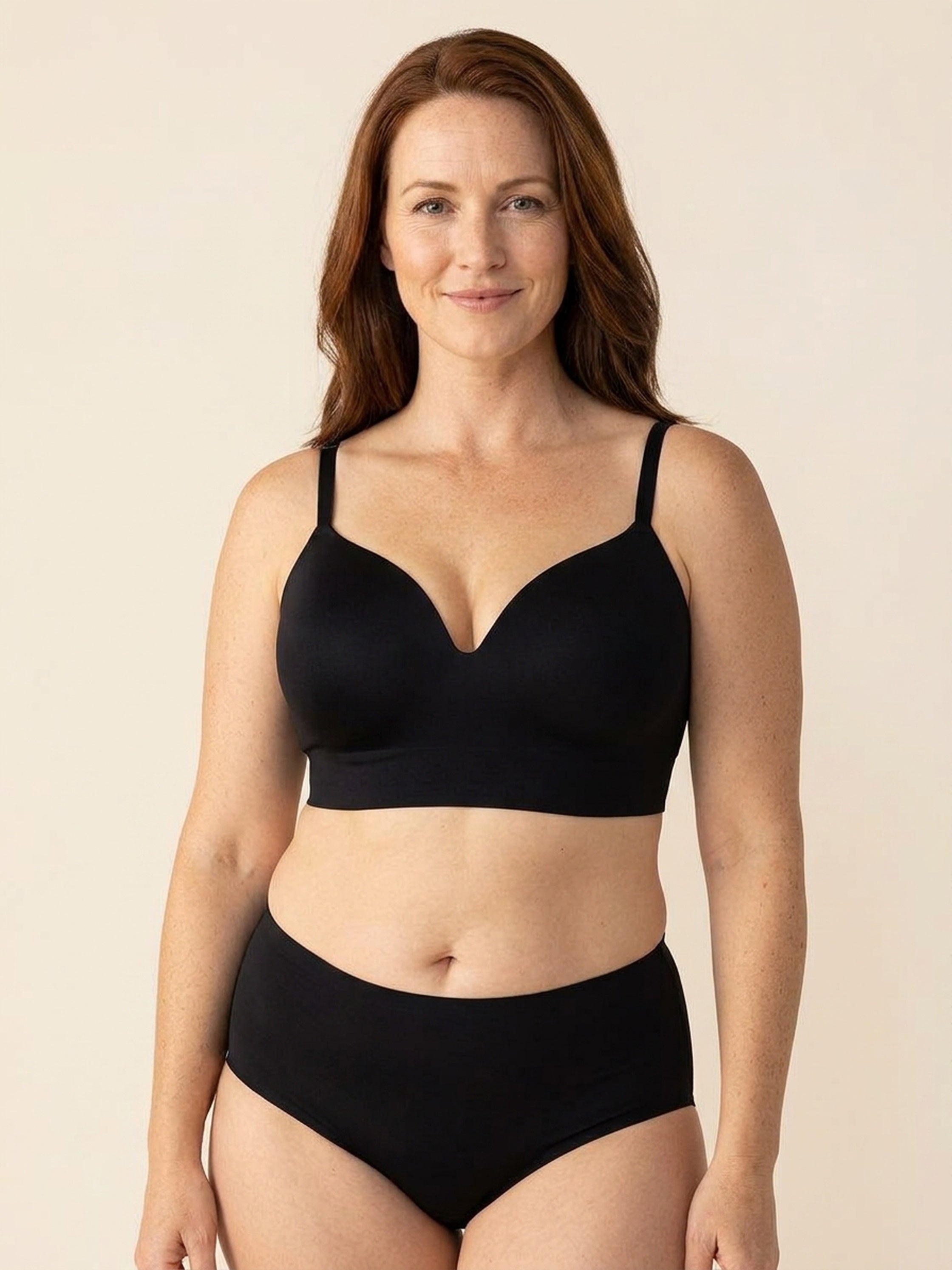Snug wireless shaping bra in black, front view on a size 40G body