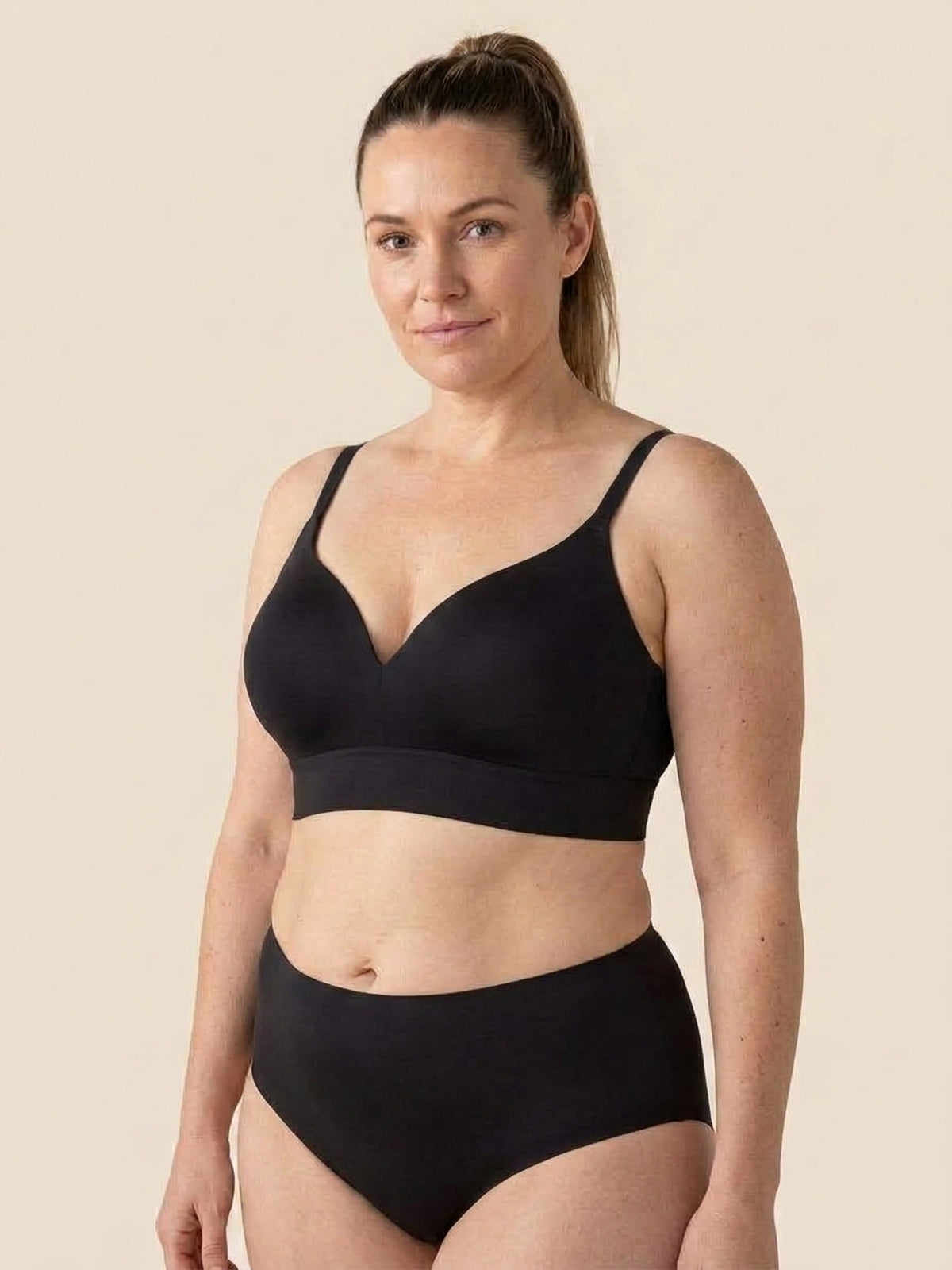 Snug wireless shaping bra in black, front view on a size 38DD body