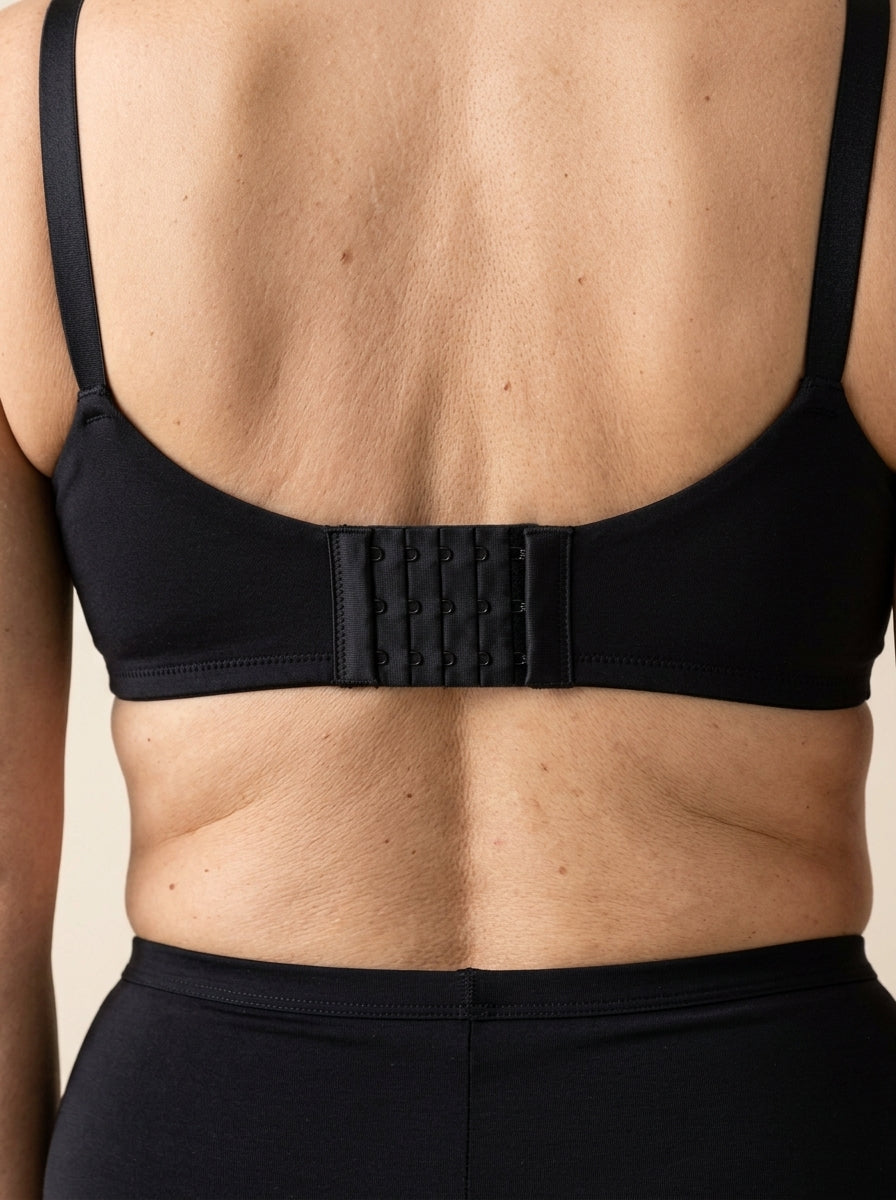 A Snug bra extender fastened into the back of a bra band