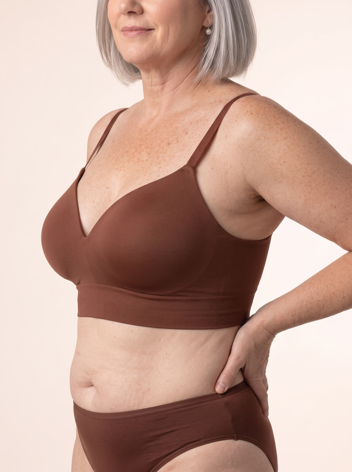 Diane in profile in the Chocolate bra — molded cup and side wing
