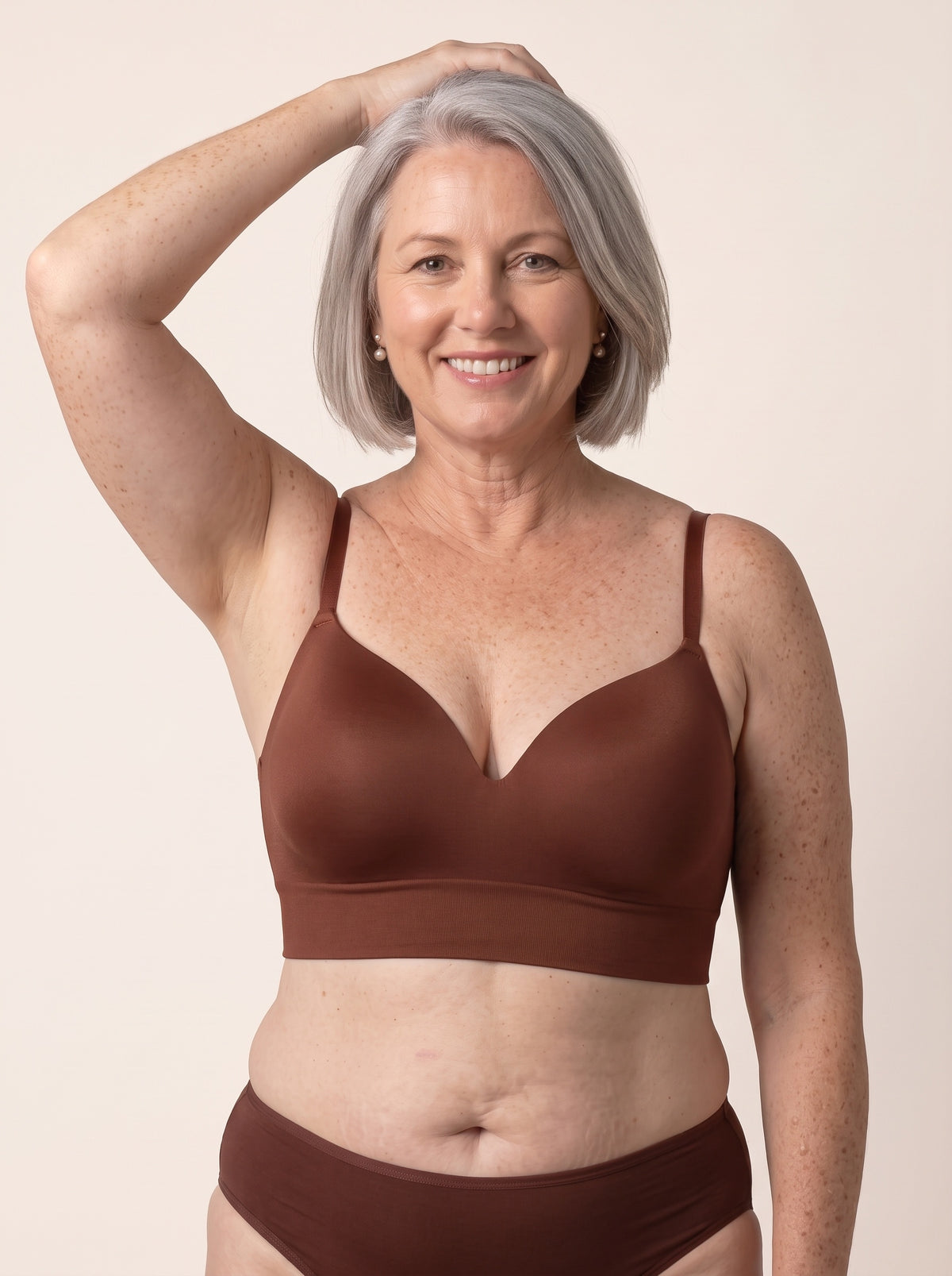 Diane, 38DD, in the Snug Wireless Shaping Bra in Chocolate — front view, one hand on her head