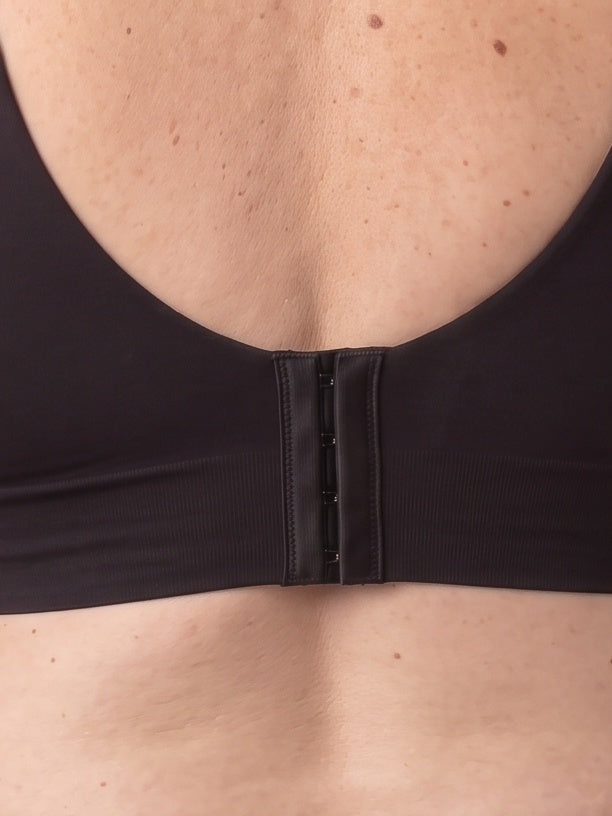Close-up of the hook-and-eye closure at the centre back of the Black bra